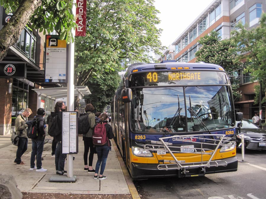 Travelers board a Route 40 bus. Travelers board a Route 40 bus.